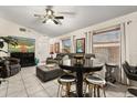 Inviting living room with a pub table, gray sectional and white tile flooring at 7951 Chediston Cir, Orlando, FL 32817