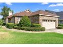 Charming single-story brick home with a two-car garage and well-manicured landscaping at 842 Bentley Green Cir, Winter Springs, FL 32708
