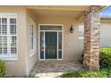 Elegant front entrance featuring decorative glass and brick columns, offering a warm welcome at 842 Bentley Green Cir, Winter Springs, FL 32708