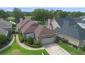 Charming single-story home featuring brick accents, manicured landscaping, and a two-car garage, all near a serene lake at 842 Bentley Green Cir, Winter Springs, FL 32708