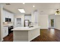 Open floor plan of the kitchen showing white cabinets, quartz countertops, and modern appliances at 8818 Villa View Cir # 304, Orlando, FL 32821