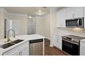 Bright kitchen featuring white cabinets, quartz countertops, and stainless steel appliances at 8818 Villa View Cir # 304, Orlando, FL 32821