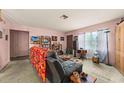 Bright living room with neutral walls, comfortable seating, and multiple windows offering ample natural light at 99 Rainbow Dr. # 4, Haines City, FL 33844