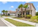 Charming two-story home features a two car garage, tile roof, front yard landscaping and brick paved drive at 1115 Oak Bluff Dr, Davenport, FL 33837