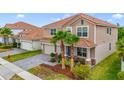 Charming two-story home features a two car garage, tile roof, front yard landscaping and brick paved drive at 1115 Oak Bluff Dr, Davenport, FL 33837