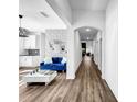 Bright living room features wood floors and modern blue sofa at 1210 Lone Palm Way, St Cloud, FL 34771