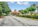 Community entrance featuring a stone and terra cotta structure with lush landscaping at 1401 Yellow Finch Dr, Davenport, FL 33837