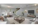 Bright open-concept floor plan featuring a living room, dining area, and staircase at 1455 Blue Horizon Dr, Clermont, FL 34714