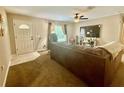 Cozy living room with neutral walls, carpet flooring, and a ceiling fan at 14598 Se 28Th Ct, Summerfield, FL 34491