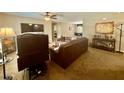 Spacious living area with carpet floors and multiple seating options at 14598 Se 28Th Ct, Summerfield, FL 34491