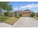 Charming single-story home with a well-manicured lawn, mature landscaping, and a two-car garage at 14848 Bonnybridge Dr, Orlando, FL 32826
