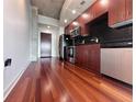 Modern kitchen features stainless steel appliances, wood cabinets, and hardwood flooring at 155 S Court Ave # 2403, Orlando, FL 32801