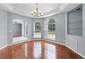 Open living area with hardwood floors, neutral paint, and large windows at 1802 Imperial Palm Dr, Apopka, FL 32712