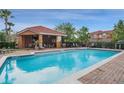Inviting community pool area featuring a covered lounge and comfortable seating at 1942 Michael Tiago Cir, Maitland, FL 32751