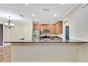 Eat-in kitchen featuring granite countertops, stainless steel appliances, and ample cabinet space at 1942 Michael Tiago Cir, Maitland, FL 32751