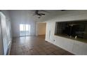 View of the living room with sliding glass doors and view to the kitchen at 1985 Japonica Rd, Winter Park, FL 32792