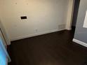 An empty room showcases dark wood flooring and neutral walls at 1985 Japonica Rd, Winter Park, FL 32792