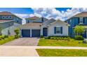 Charming single-Gathering home boasts a well-manicured lawn and a two-car garage for ample parking at 2591 Seagirt Way, Clermont, FL 34711