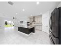 Open-concept kitchen with a large island and stainless steel appliances at 2591 Seagirt Way, Clermont, FL 34711