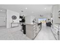 Modern kitchen features granite countertops, stainless steel appliances, and an open design for entertaining at 2591 Seagirt Way, Clermont, FL 34711