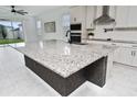 Kitchen island featuring a granite countertop, ample space and an undermount sink at 2591 Seagirt Way, Clermont, FL 34711