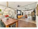 Open-concept dining and living area, featuring wood floors, modern lighting, and ample space for entertaining at 2623 Gables Dr, Eustis, FL 32726