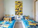 Whimsical bedroom featuring two twin beds with Minion-themed decor and light blue walls at 2660 Sunrise Shores Dr, Kissimmee, FL 34747