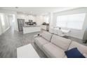 Open-concept living and dining area with modern decor and abundant natural light at 3027 Addison Blvd, St Cloud, FL 34771