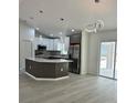Modern kitchen featuring a spacious island, stainless steel appliances, and stylish pendant lighting at 3082 Se 140Th Ln, Summerfield, FL 34491