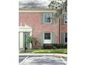 Close-up view of a brick condo with green shutters and a well-maintained front entrance at 316 Georgetown Dr, Casselberry, FL 32707