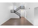 Bright living room featuring high ceilings, wood-look flooring, and staircase at 4045 Crossroads Pl, Casselberry, FL 32707