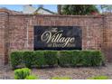 Elegant brick community signage reading 'The Village at Deer Run' surrounded by manicured greenery at 4045 Crossroads Pl, Casselberry, FL 32707