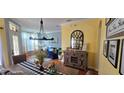 Open-concept dining area leading to a living room with blue couch at 4102 Feldspar Trl, Orlando, FL 32826