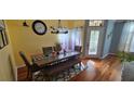 Inviting dining room with wood floors, table with seating, and natural light at 4102 Feldspar Trl, Orlando, FL 32826