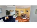 Bright open-concept living room with hardwood floors and modern decor at 4102 Feldspar Trl, Orlando, FL 32826