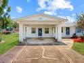 Close up of home's covered entrance, showing address and unique door design at 413 5Th S St, Dundee, FL 33838