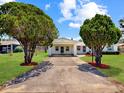 Inviting home with covered carport, driveway, and mature landscaping at 413 5Th S St, Dundee, FL 33838