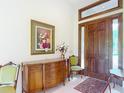 Charming foyer with a wood door, accent furniture, and a decorative painting at 502 Canopy Ln, Lady Lake, FL 32159