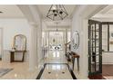 Grand foyer with high ceilings, elegant columns, and black and white tile accents at 506 Golfpark Dr, Celebration, FL 34747