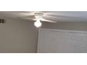 Bedroom with a ceiling fan, closet, light gray walls, and a window at 5267 Images Cir # 102, Kissimmee, FL 34746