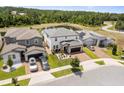 Expansive aerial view of a two-story home in a well-planned community with pond views at 5457 Carrara Ct, St Cloud, FL 34771