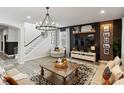 Inviting living room with modern chandelier, cozy seating, and elegant wall decor at 5457 Carrara Ct, St Cloud, FL 34771