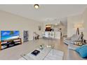 Bright and open living room with tile floors and a view of the dining area and kitchen at 6201 Goethe St # 103, Orlando, FL 32835
