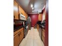 Efficient kitchen design includes updated appliances, tiled backsplash, and ample cabinet space for storage at 6335 Contessa Dr # 310, Orlando, FL 32829