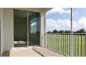 Screened-in patio with sliding glass doors offering views of a green lawn and scattered trees at 725 Ocean Course Ave, Davenport, FL 33896