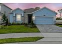 Charming one-story home with a blue facade, well-manicured lawn, and stylish stone accents at 8018 Colby Cir, Orlando, FL 32817