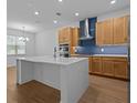 Modern kitchen featuring a large island, stainless steel appliances, and stylish wood cabinetry at 8018 Colby Cir, Orlando, FL 32817