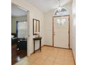 Welcoming foyer with light tile flooring, a decorative front door, and an arched window above the entry at 1016 Seminole Creek Dr, Oviedo, FL 32765