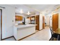 Functional kitchen featuring light countertops, wood cabinets, and direct access to the dining and living areas at 1016 Seminole Creek Dr, Oviedo, FL 32765