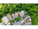Aerial view of a home with a private pool, surrounded by lush greenery and neighboring houses at 10255 Cody Ln, Orlando, FL 32825